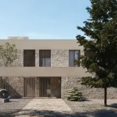 Una casa moderna con fachada de piedra y estuco, ideal para renovar fachada casa. El camino de entrada conduce a una puerta de madera.